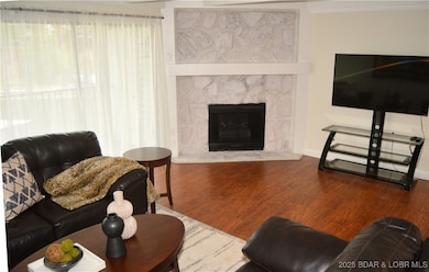 Living room with stone fireplace feature.