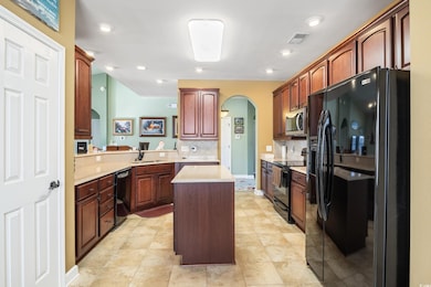 Kitchen featuring a center island, black appliance