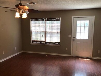 Living room with door to backyard patio.