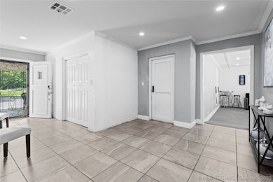 Large living area with tile flooring.