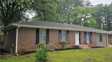 Ranch-style house with brick siding and a front yard