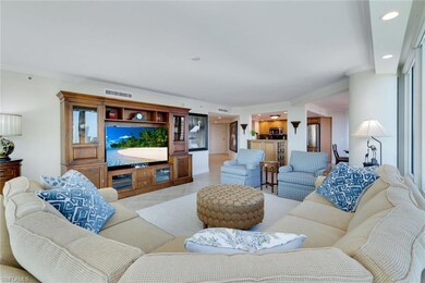 Living room with light tile patterned floors and c