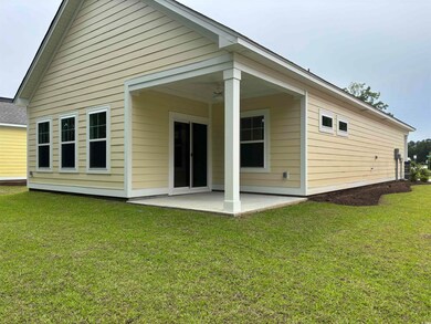 Rear view of property with a patio and a lawn