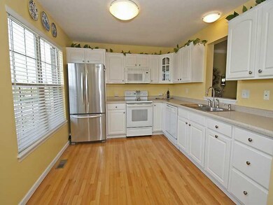 Kitchen. Eat-in kitchen with white cabinets, hardw