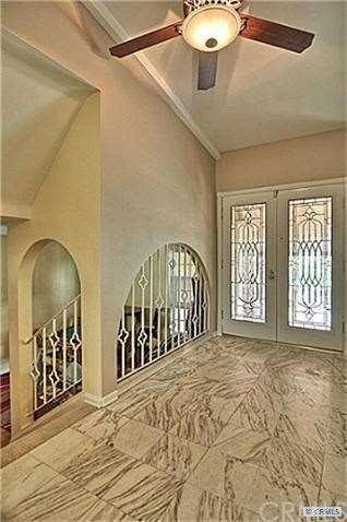 Front entryway with marble flooring and beveled gl