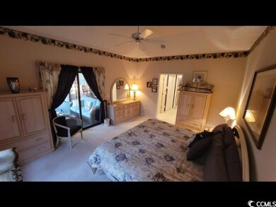 Bedroom featuring ceiling fan, light colored carpe