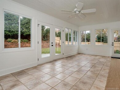 Sun room features three walls of windows, spanish 