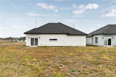 Rear view of house featuring a yard