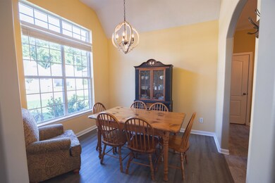 Dining space with dark hardwood / wood-style floor
