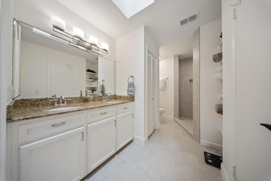 Remodeled full bathroom featuring double vanities,