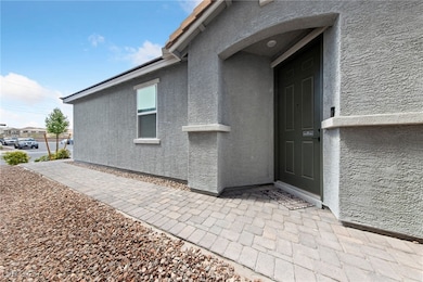 View of exterior entry featuring stucco siding and