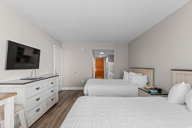 Bedroom with wood finished floors and ensuite bathroom