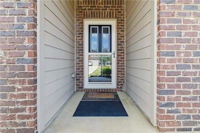 View of exterior entry featuring brick siding