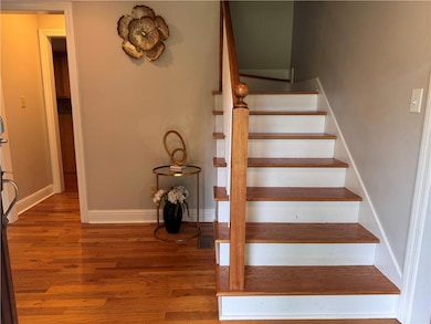 Stairway with baseboards and wood finished floors