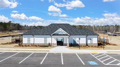 View of building exterior featuring uncovered parking