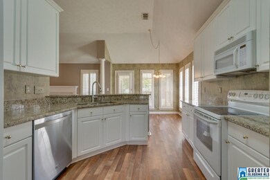 Pass through kitchen with granite counters, some s