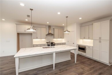 Look at this kitchen! Its very nice for cooking, hanging out, and you won't miss anytime with your family. Pictures represent a previously built home, not the actual home.