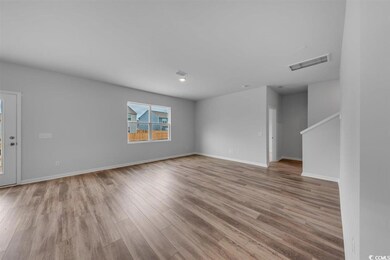 Spare room featuring baseboards, visible vents, an