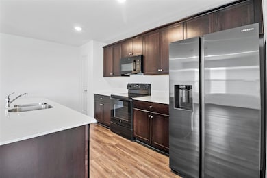 Kitchen featuring light wood-type flooring, light 