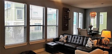 Living area featuring a chandelier and baseboards