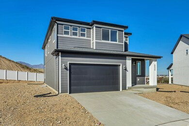 View of front of home with a garage, driveway, and a mountain view