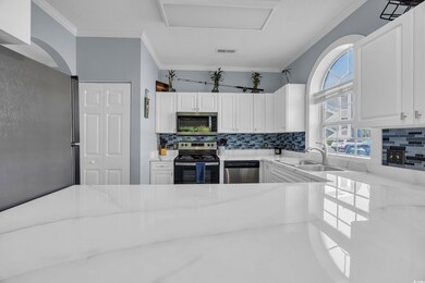 Kitchen featuring light stone counters, decorative