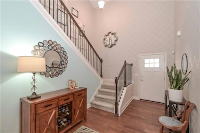 Entrance foyer featuring dark wood-type flooring, 