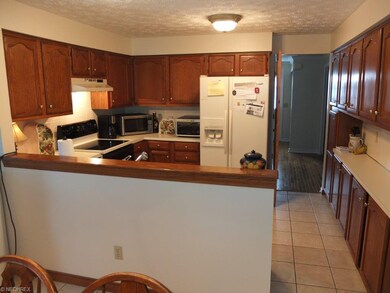 Kitchen with ceramic tile floor.
