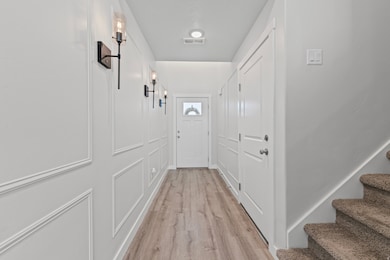 Doorway featuring wood finished floors and stairway