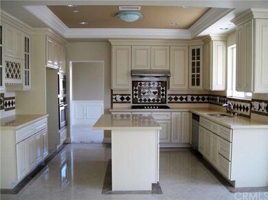 KITCHEN WITH BUILT-IN STAINLESS STEEL APPLIANCES A