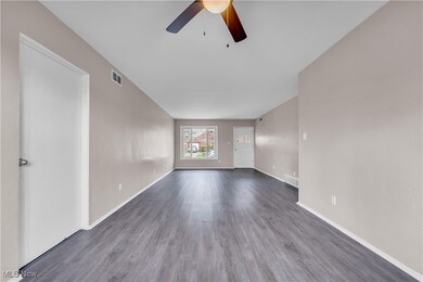 Unfurnished room with wood finished floors, ceiling fan, and baseboards