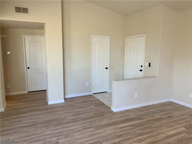 Unfurnished room featuring wood finished floors, b