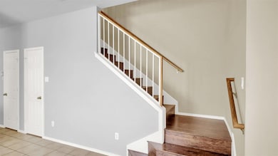 Stairs featuring baseboards and tile patterned flooring