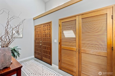 Enter in a true foyer with soaring ceilings and a large coat closet.  New tile floors in entries, kitchen and bathrooms.