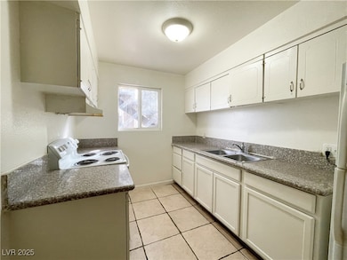 Kitchen featuring white cabinetry, white appliance