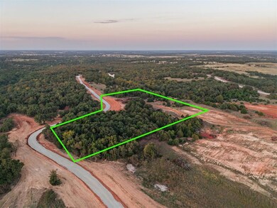 Aerial view at dusk of a forest view and property parcel outlined