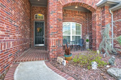 Covered front courtyard with nice landscaping.