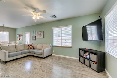 Living area with light wood-type flooring, baseboa