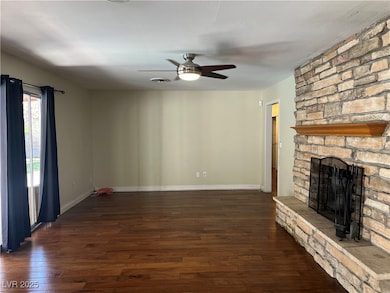 Unfurnished living room featuring a ceiling fan, h