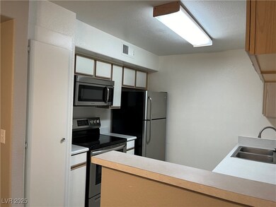 Kitchen featuring stainless steel appliances, a si