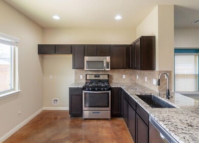 Kitchen with finished concrete flooring, light st
