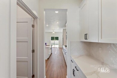 Corridor featuring a sink and wood finished floors