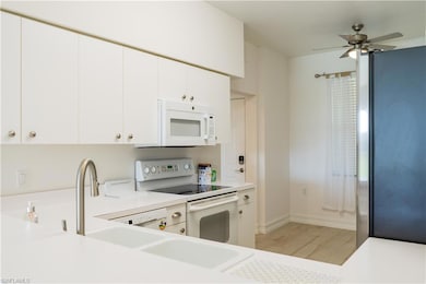 Kitchen featuring light countertops, a ceiling fan
