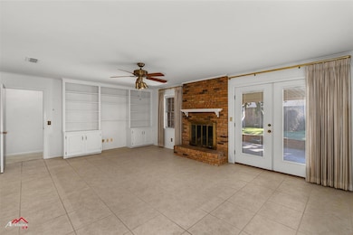 Unfurnished living room featuring french doors, li