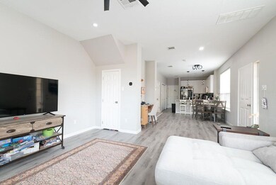 Living area with baseboards, recessed lighting, l