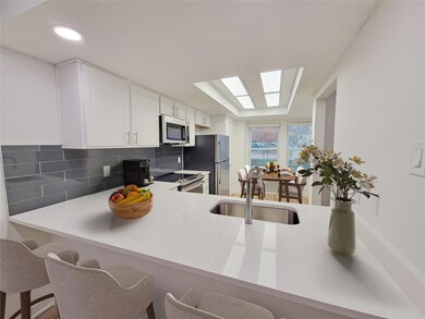 Kitchen featuring sink, a breakfast bar area, stai