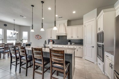 The open concept kitchen features a breakfast bar 