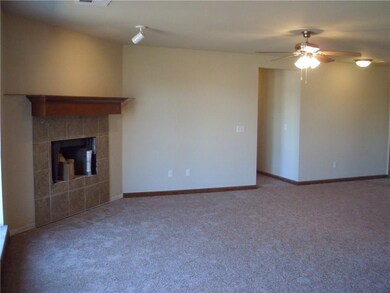 Nice sized living room with ceiling fan and fir pl