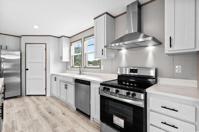 Kitchen with white cabinets, light hardwood / wood