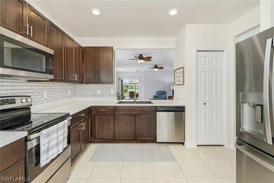 Kitchen featuring dark brown cabinets, ceiling fan